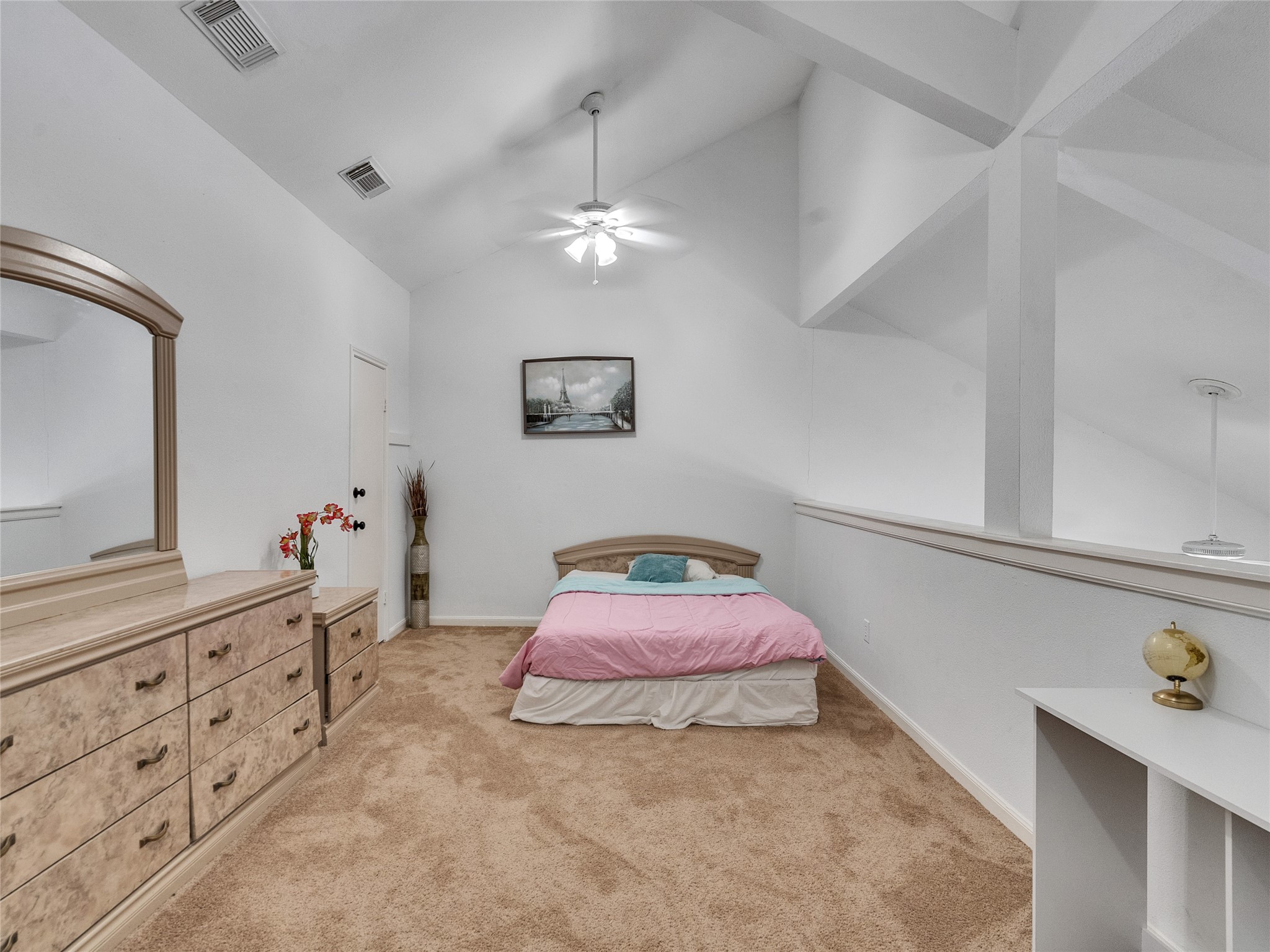 174 April Point Drive South Conroe, TX 77356 - Photo 7 of 38 a bedroom with a bed a chandelier and a dresser