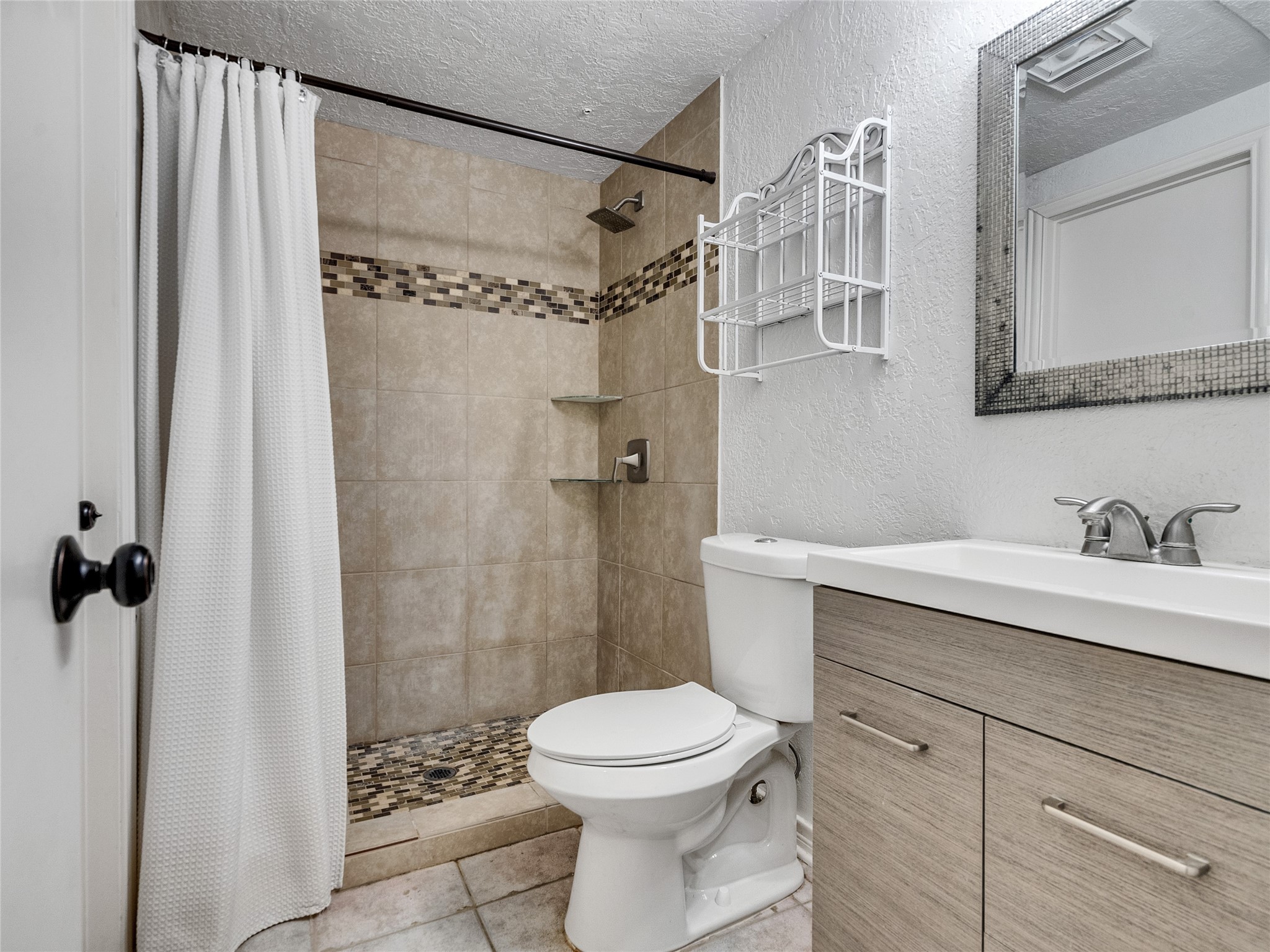 174 April Point Drive South Conroe, TX 77356 - Photo 10 of 38 a bathroom with a granite countertop sink toilet and shower