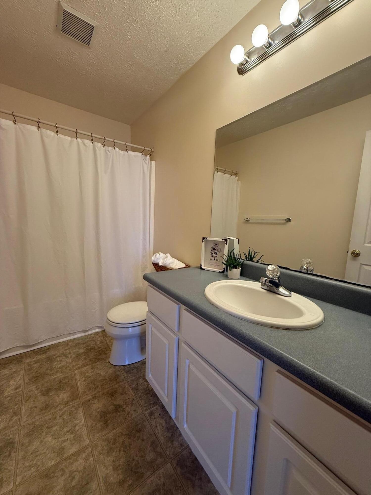 322 Signal Drive Rossville, GA 30741 - Photo 14 of 17 a bathroom with a double vanity sink toilet and a mirror