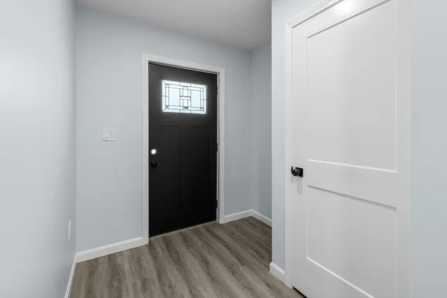 a view of a hallway with wooden floor