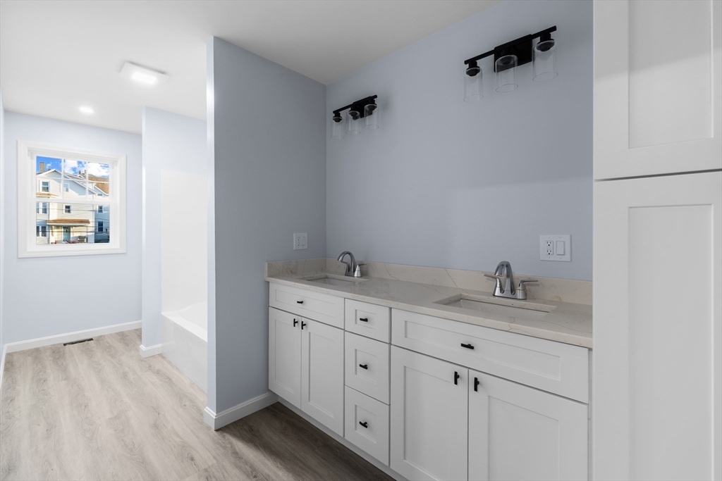 81 Hunter Street Fall River, MA 02721 - Photo 8 of 15 a bathroom with a granite countertop sink mirror and vanity