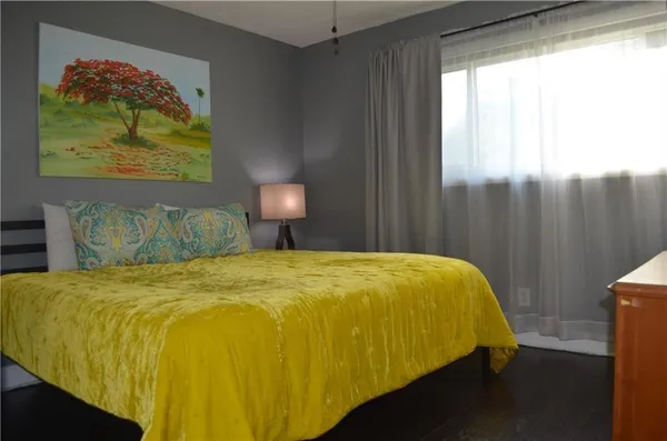 a bed sitting in a bedroom next to a window