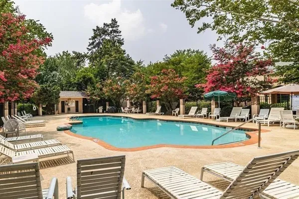 a view of a house with pool and chairs