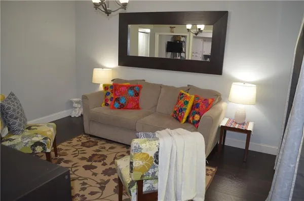 a living room with furniture and a mirror