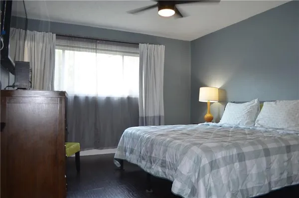 a bedroom with a bed and window