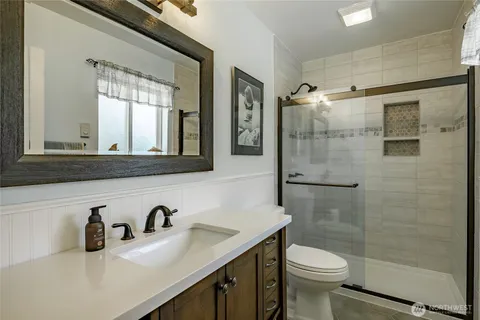a bathroom with a sink toilet and shower