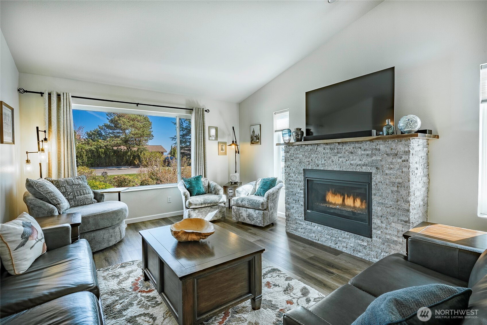 8209 Comox Road Birch Bay, WA 98230 - Photo 3 of 24 a living room with furniture a flat screen tv and a fireplace