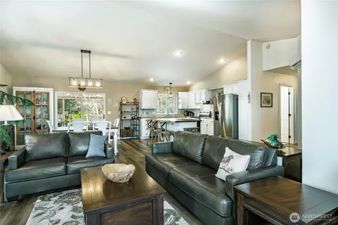 a living room with furniture and a chandelier