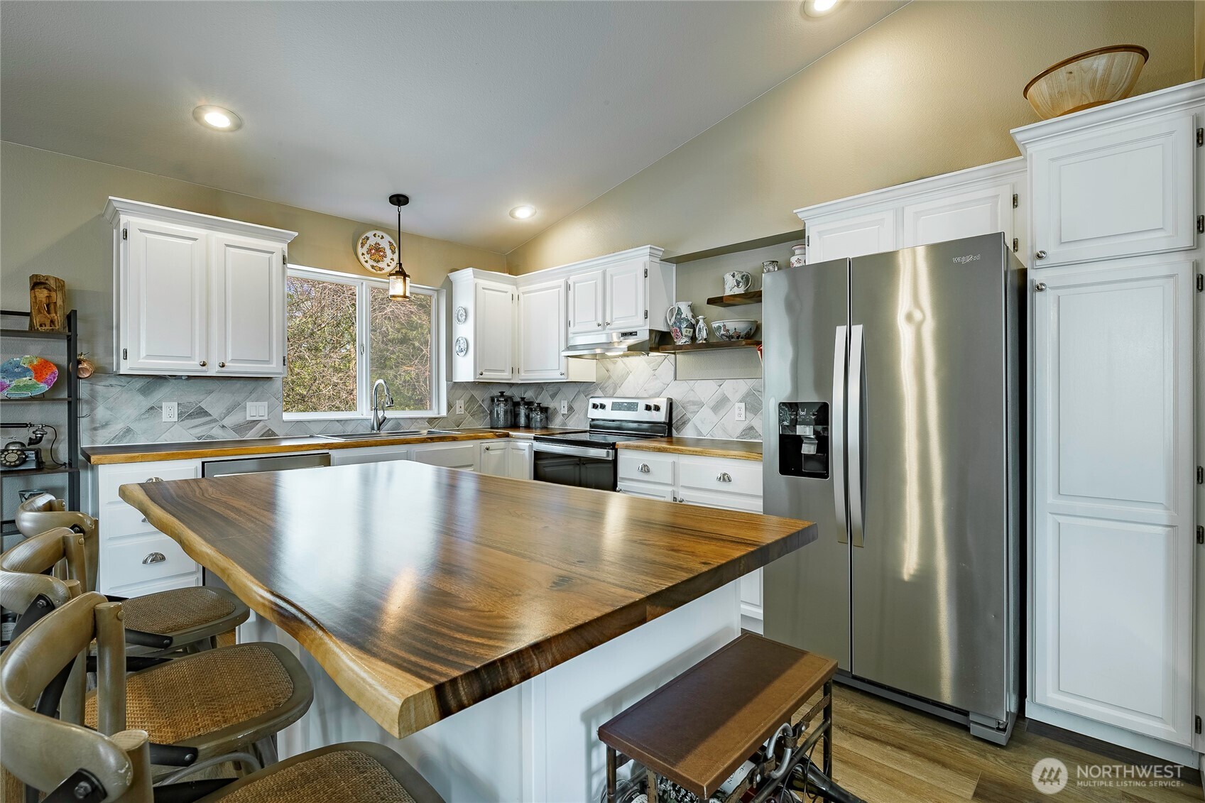 8209 Comox Road Birch Bay, WA 98230 - Photo 8 of 25 a large kitchen with kitchen island a large counter top space a sink stainless steel appliances and cabinets