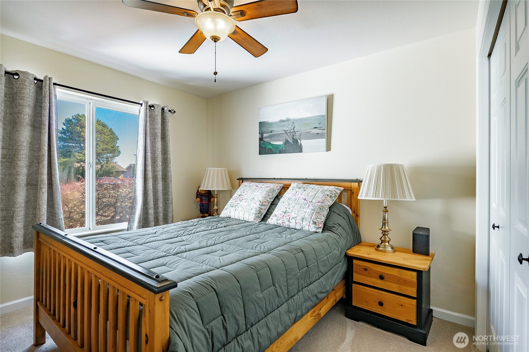8209 Comox Road Birch Bay, WA 98230 - Photo 10 of 25 a bedroom with a bed and a chandelier