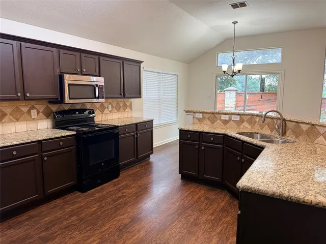 a kitchen with granite countertop wooden cabinets and a granite counter tops