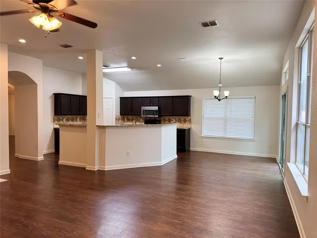 an open kitchen with a flat screen tv and kitchen view