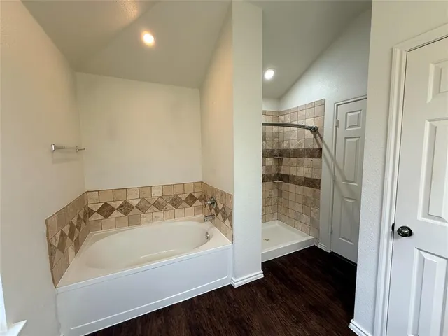 a bathroom with a bathtub and shower