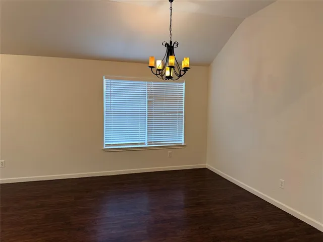 a view of a room with wooden floor and ceiling fan