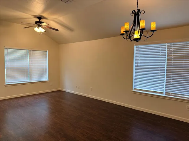 a view of an room with wooden floor and windows
