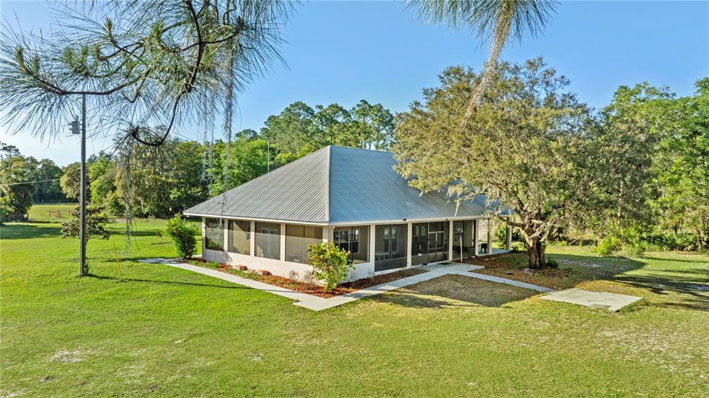 1045 Buckles Road Pierson, FL 32180 - Photo 1 of 19 a view of a house with a backyard and a tree