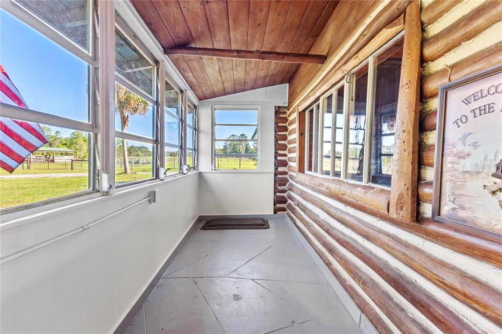 1045 Buckles Road Pierson, FL 32180 - Photo 11 of 19 a view of an entryway with a floor to ceiling window and a kitchen view