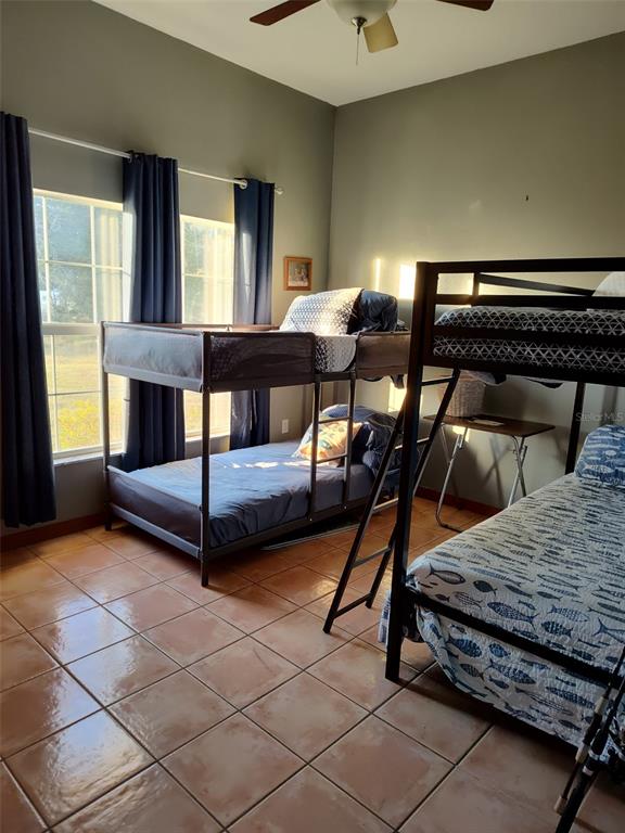 1045 Buckles Road Pierson, FL 32180 - Photo 16 of 25 a bedroom with furniture and a window