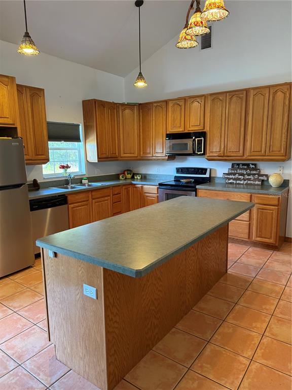 1045 Buckles Road Pierson, FL 32180 - Photo 8 of 25 a kitchen with stainless steel appliances granite countertop a stove a sink dishwasher and a refrigerator