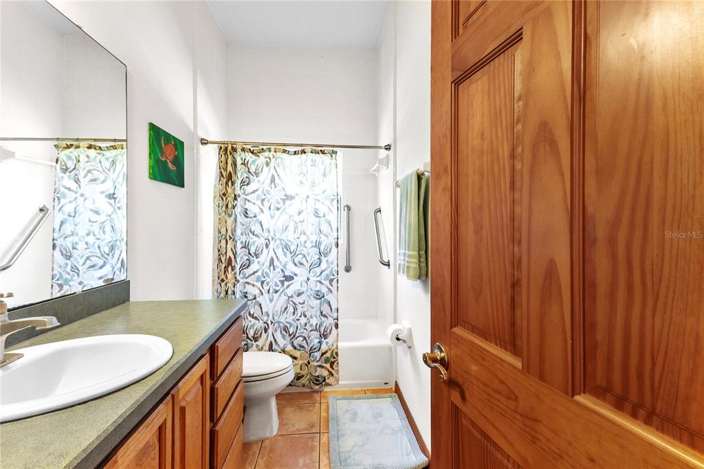 1045 Buckles Road Pierson, FL 32180 - Photo 8 of 19 a bathroom with a sink a toilet and shower curtain