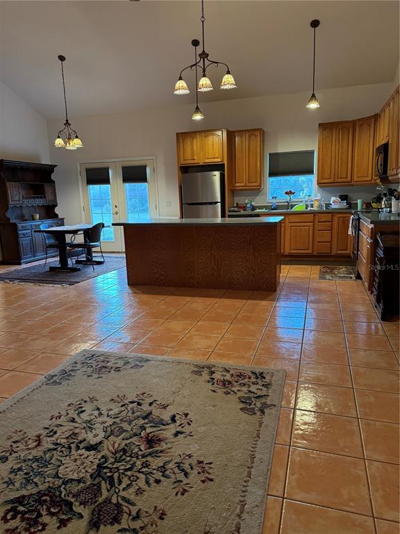 1045 Buckles Road Pierson, FL 32180 - Photo 9 of 25 a large kitchen with cabinets and a wooden floor