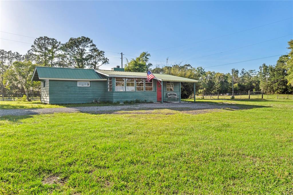 1045 Buckles Road Pierson, FL 32180 - Photo 10 of 19 a view of a house with a swimming pool