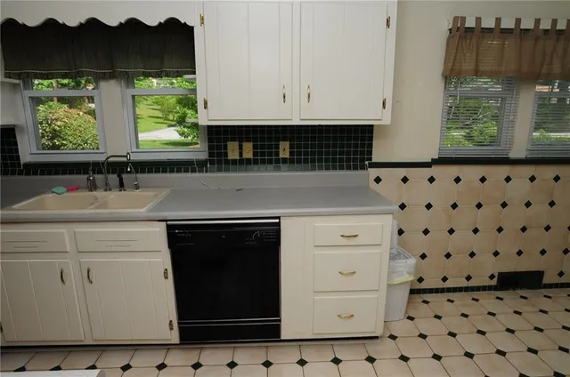 a kitchen with a sink a stove and a window