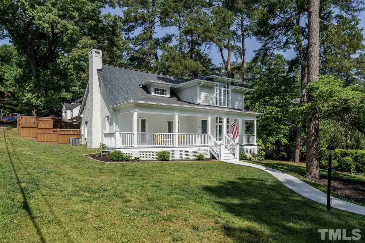 1001 Canterbury Road Raleigh, NC 27607 - Photo 2 of 29 a front view of a house with a yard table and chairs