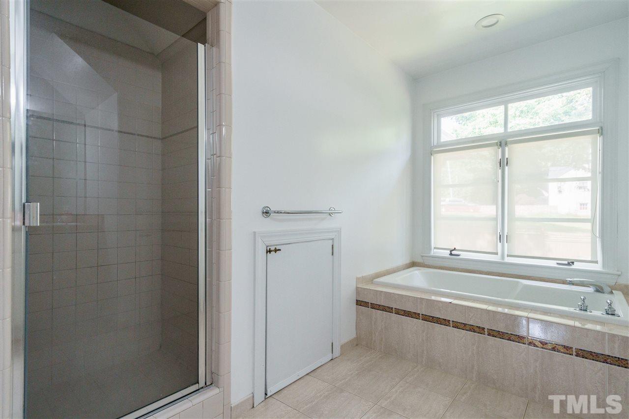 1001 Canterbury Road Raleigh, NC 27607 - Photo 18 of 29 a bathroom with a bathtub and next to a window