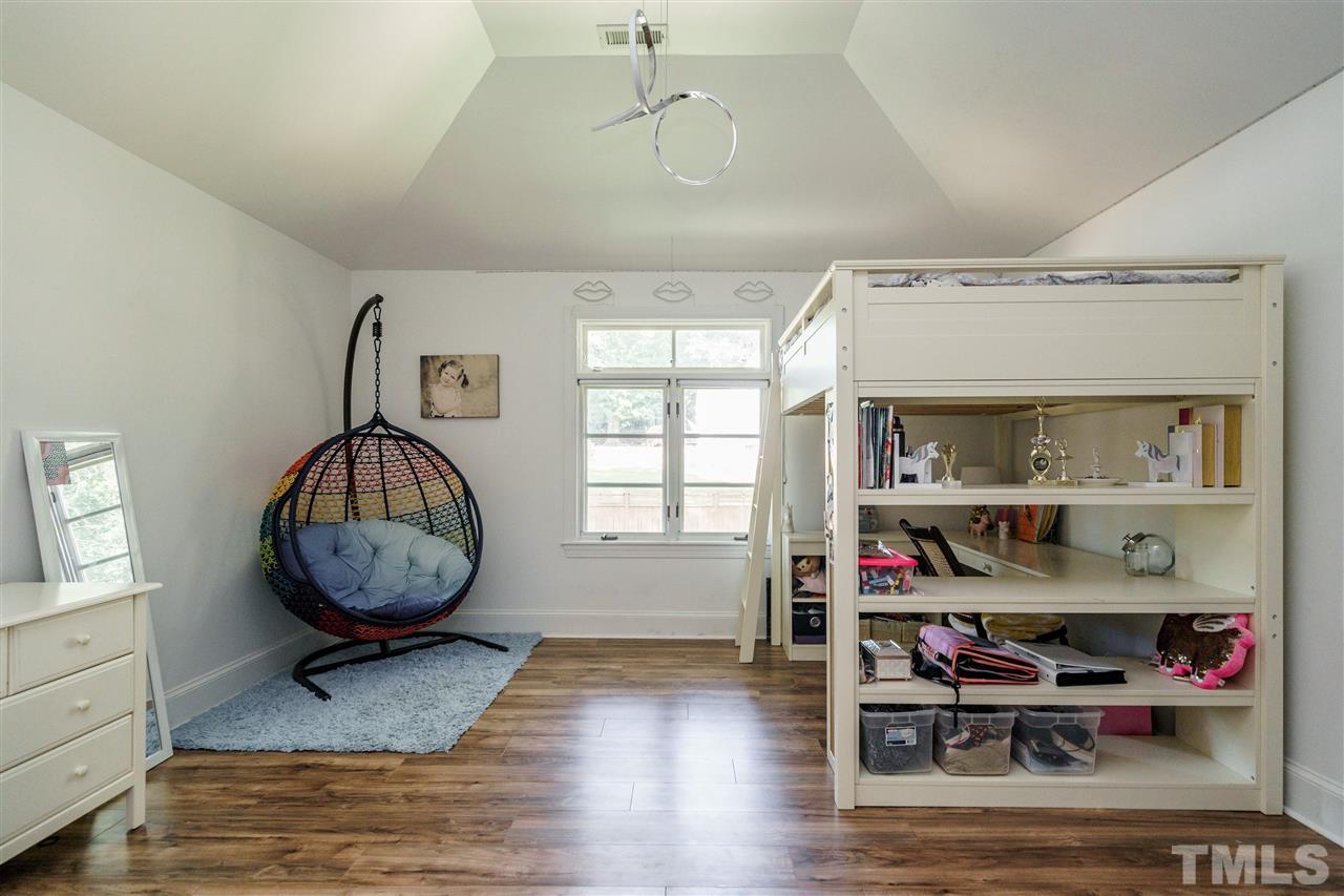 1001 Canterbury Road Raleigh, NC 27607 - Photo 20 of 29 a room with lots of books and a table