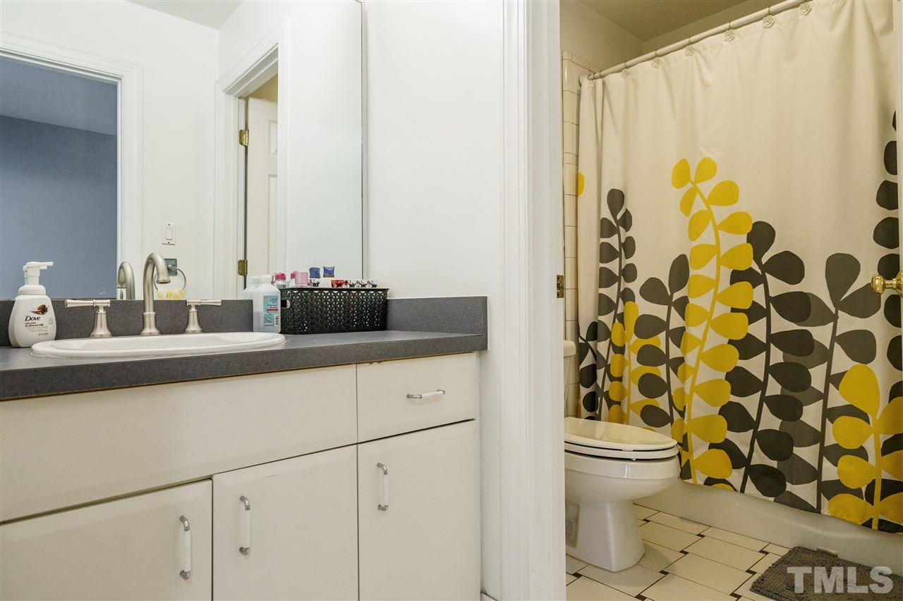1001 Canterbury Road Raleigh, NC 27607 - Photo 21 of 29 a bathroom with a double vanity sink toilet and shower