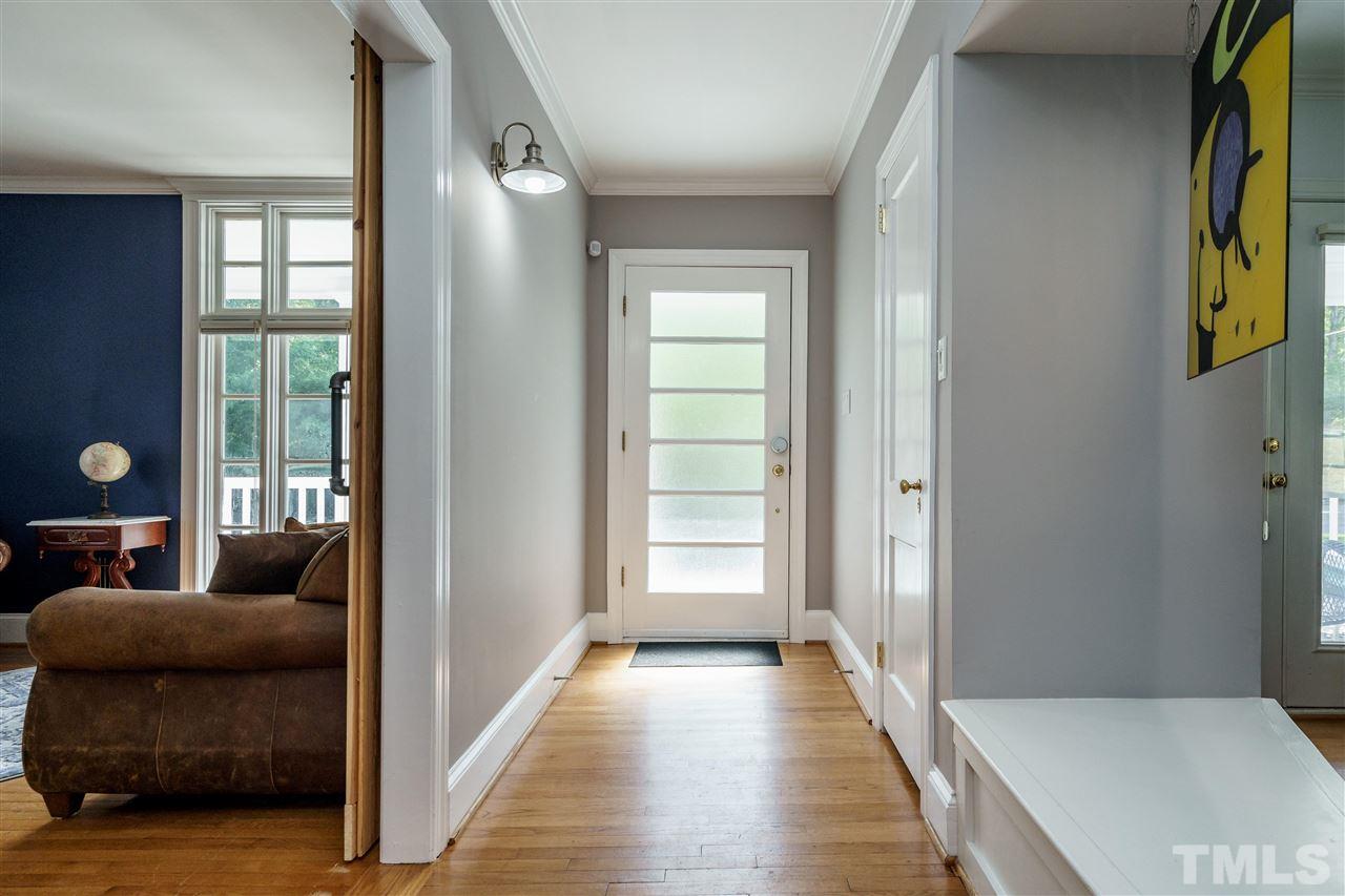 1001 Canterbury Road Raleigh, NC 27607 - Photo 7 of 29 a hallway with windows and stairs