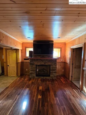 a view of a room with wooden floor and a fireplace