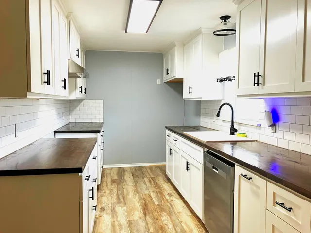 a kitchen with sink cabinets and a window