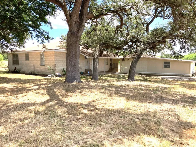 a view of a house with snow on the tree