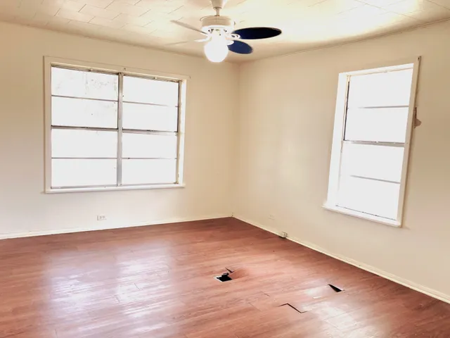 an empty room with windows and closet