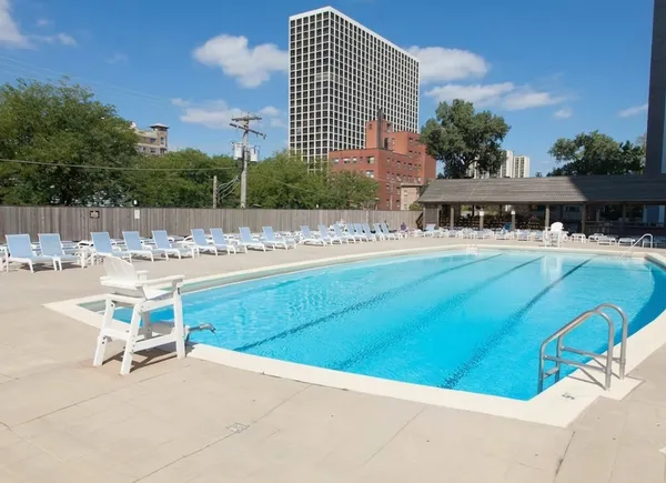 a view of swimming pool with outdoor seating and plants
