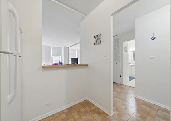 a view of a room with wooden floor and bathroom