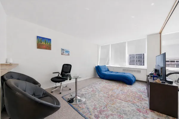 a bedroom with furniture and a window