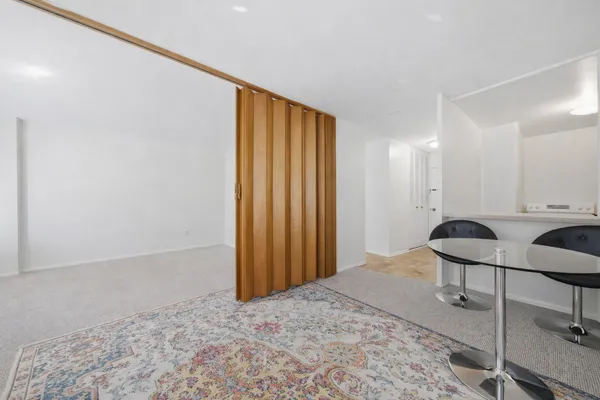 a view of a room with a wooden floor and chair
