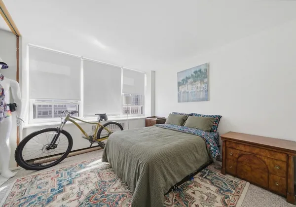 a bedroom with a bed and a dresser