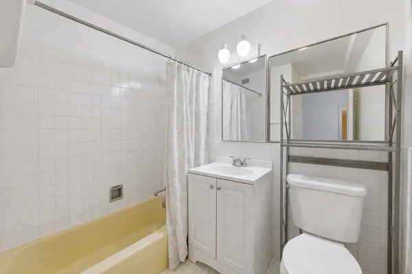 a bathroom with a toilet a sink and bathtub
