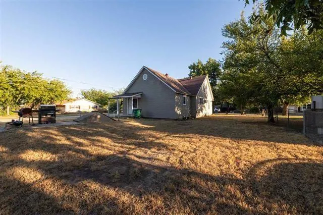 a view of a yard and front view of a house