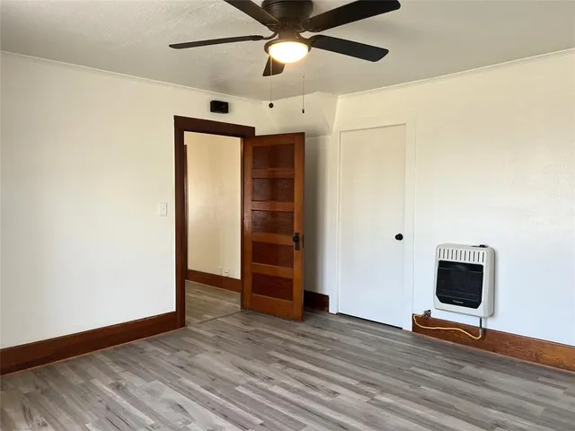 a view of room with wooden floor and ceiling fan