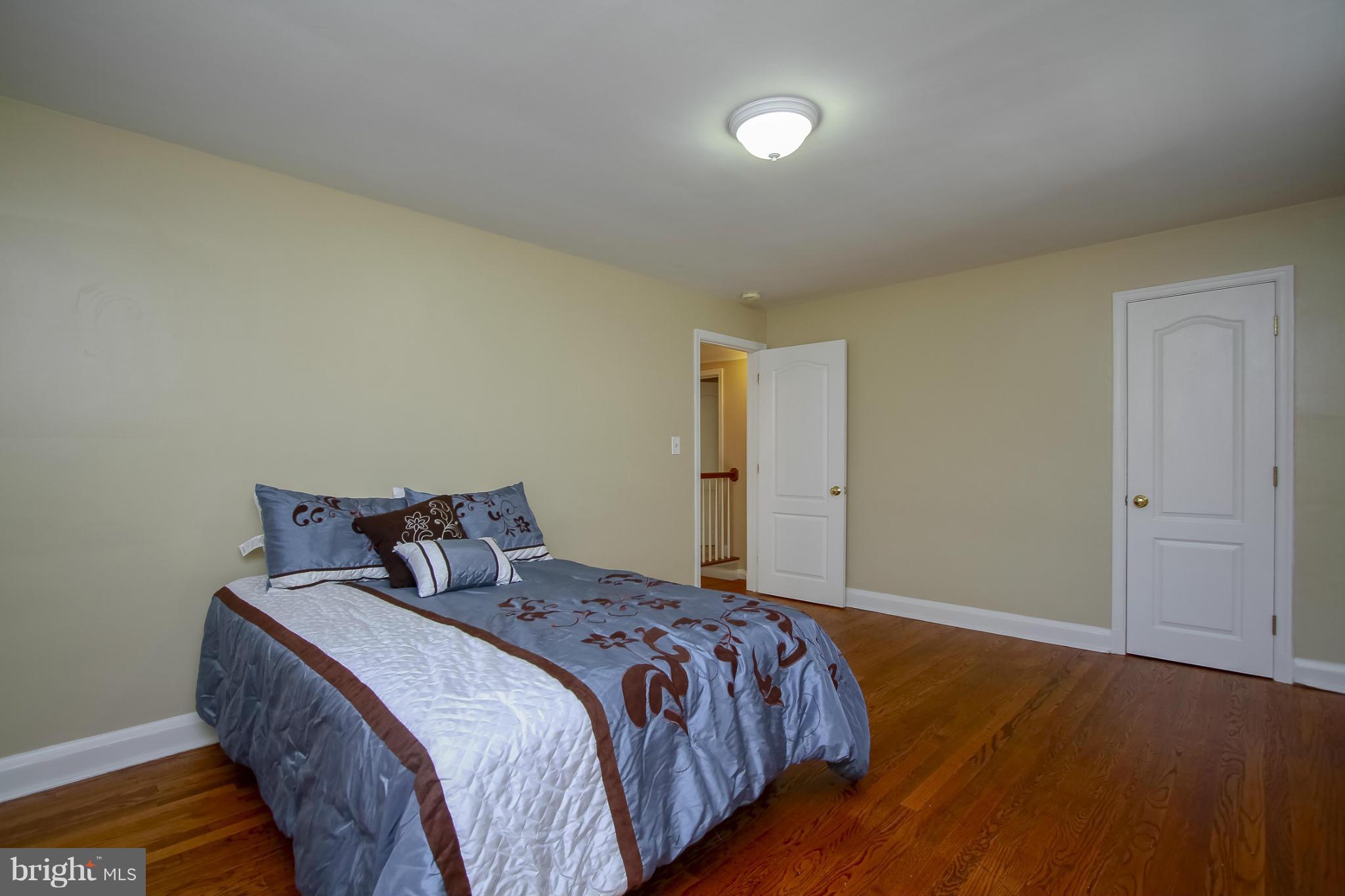 930 Litchfield Road Baltimore, MD 21239 - Photo 19 of 24 a bed sitting in a bedroom next to a bathroom