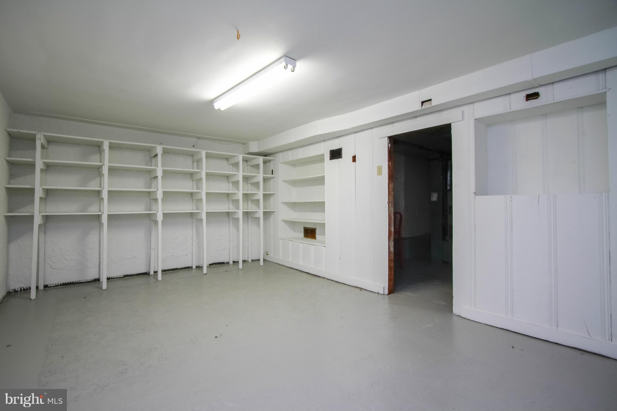 930 Litchfield Road Baltimore, MD 21239 - Photo 21 of 24 a view of an empty room with a white cabinet and a window