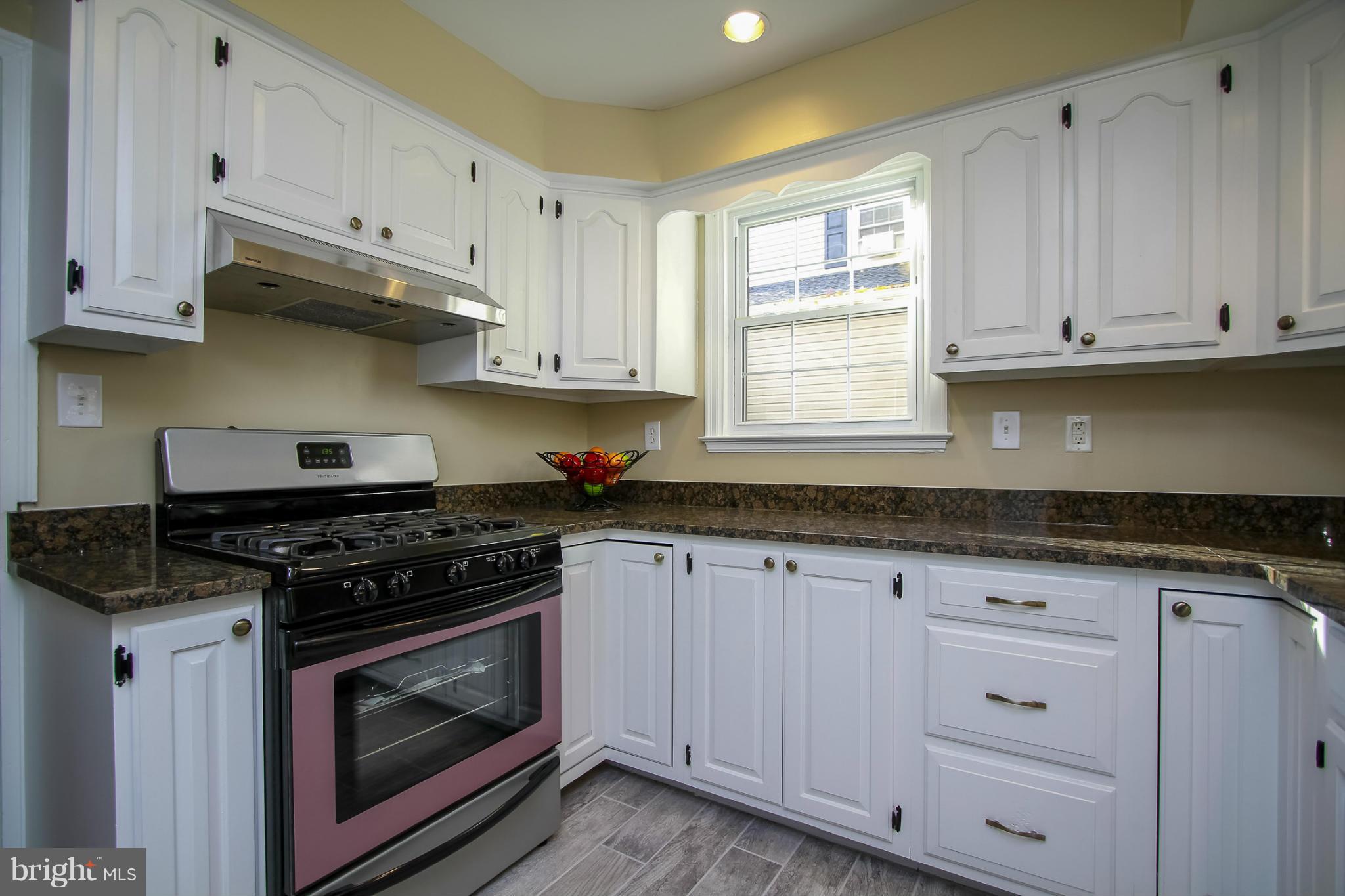 930 Litchfield Road Baltimore, MD 21239 - Photo 5 of 24 a kitchen with granite countertop white cabinets and stainless steel appliances