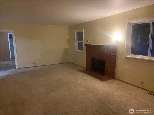 an empty room with a fireplace