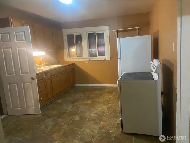 a room with a refrigerator and washer