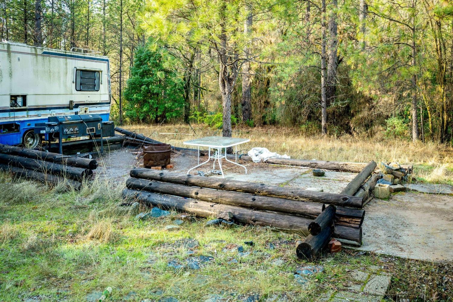 14941 Deadmans Flat Road Grass Valley, CA 95949 - Photo 22 of 45 a backyard of a house with barbeque oven table and chairs